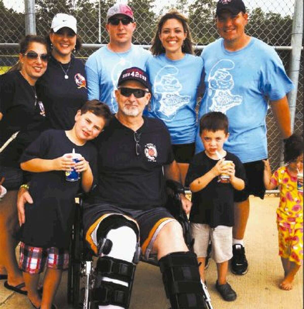 Left to right, (back row) Nicole Garner, who lost her brother Robert in the recent Houston motel fire, poses for a picture with his wife, Amy Yarbrough, Forrest Dowling, who is the son of Captain William Dowling, still hospitalized, Ashley Romagus, Michael Romagus, (front row) Austin Yarbrough, Robert Yarbrough, Trey Romagus and Molly Romagus