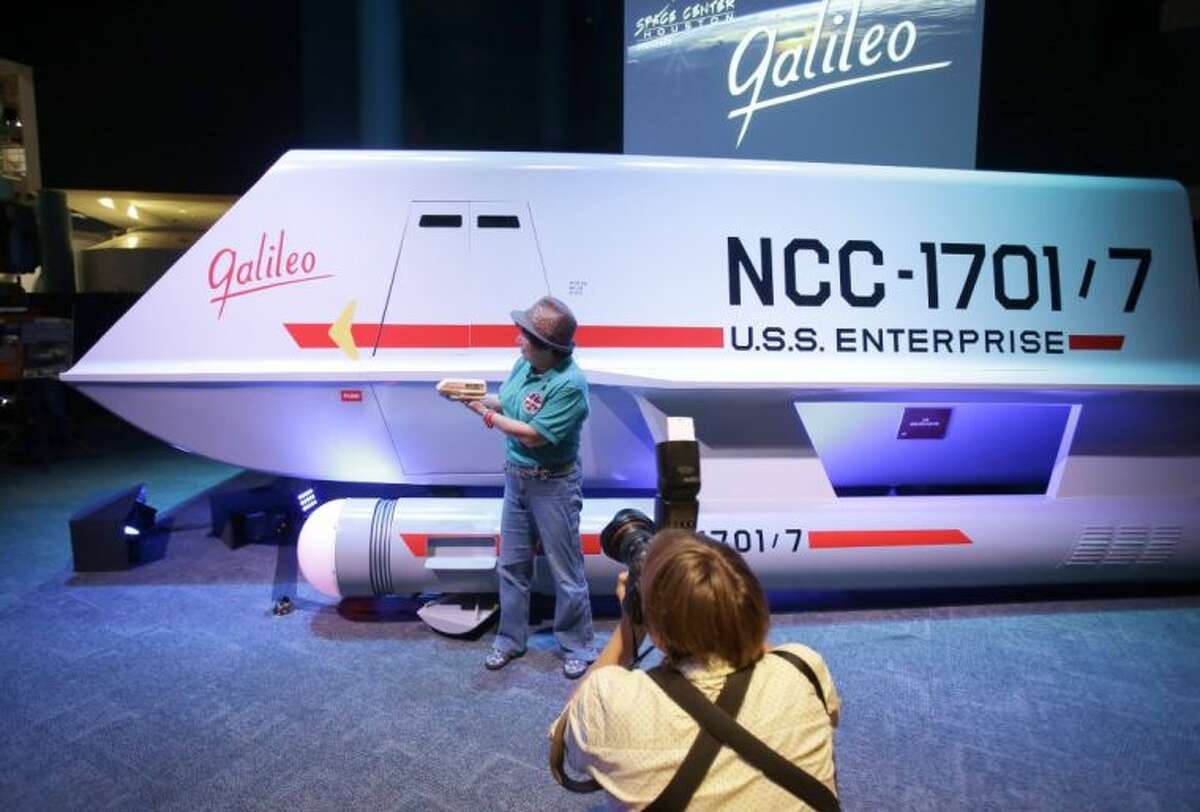 Candy Torres is photographed standing in front of the restored space shuttle Galileo from the 1960’s television show Star Trek holding her plastic toy version of the vehicle at Space Center Houston Wednesday in Houston. The restored shuttlecraft that crash-landed on a hostile planet in the 1967 episode “The Galileo Seven” was officially unveiled at the Space Center Houston before a crowd of die-hard Star Trek fans.