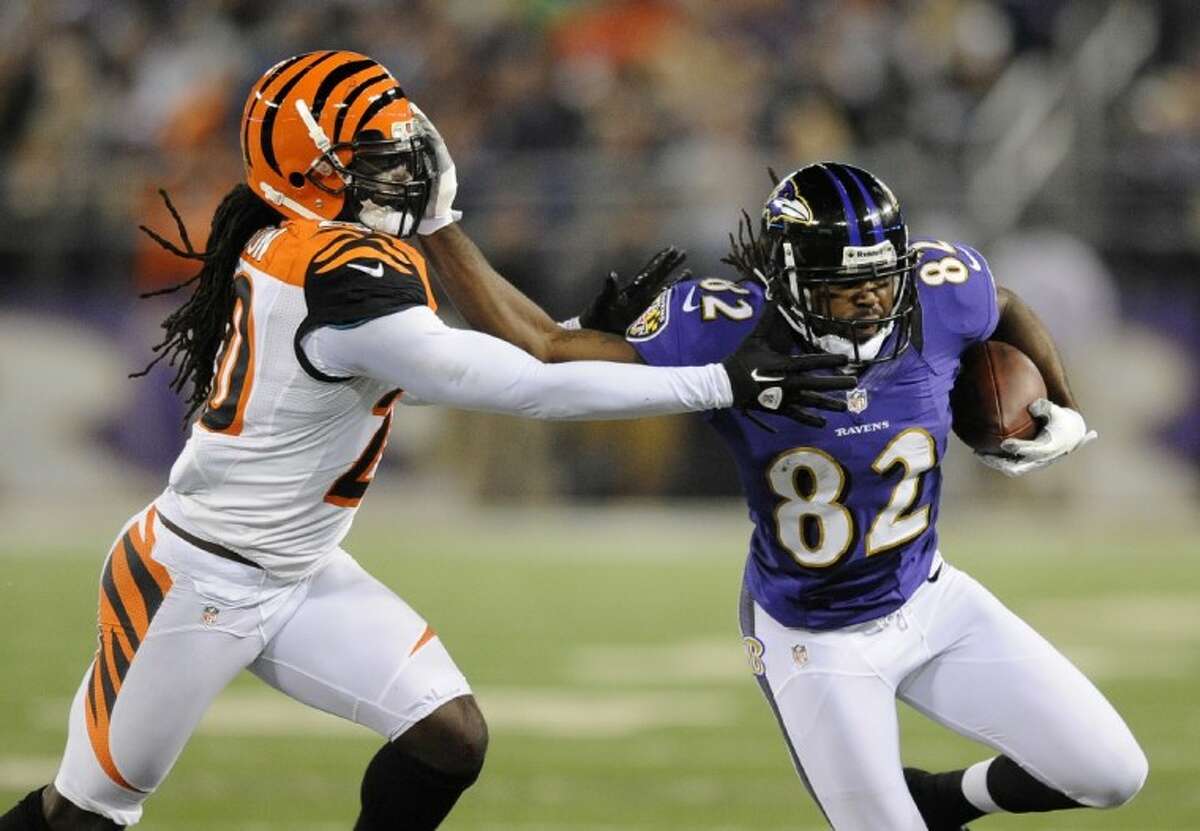 Baltimore Ravens wide receiver Torrey Smith, right, attempts to rush past Cincinnati Bengals safety Reggie Nelson in the second half of an NFL football game in Baltimore, Monday, Sept. 10, 2012. (AP Photo/Nick Wass)