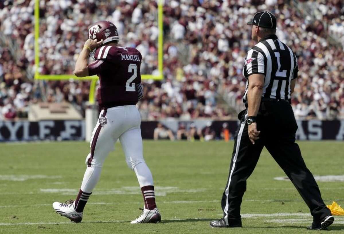 Texas A&M’s Johnny Manziel walks away from an official after receiving a personal foul penalty during the fourth quarter against Rice on Saturday in College Station.