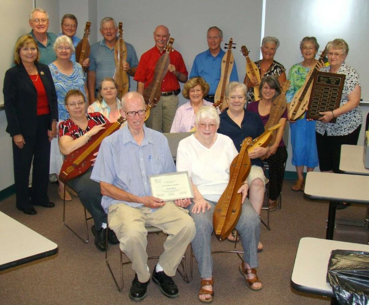 Holding her dulcimer, Nancy Price, front right, Lone Star College-Montgomery’s Academy for Lifelong Learning’s Instructor of the Year, is surrounded by current and former dulcimer students.
