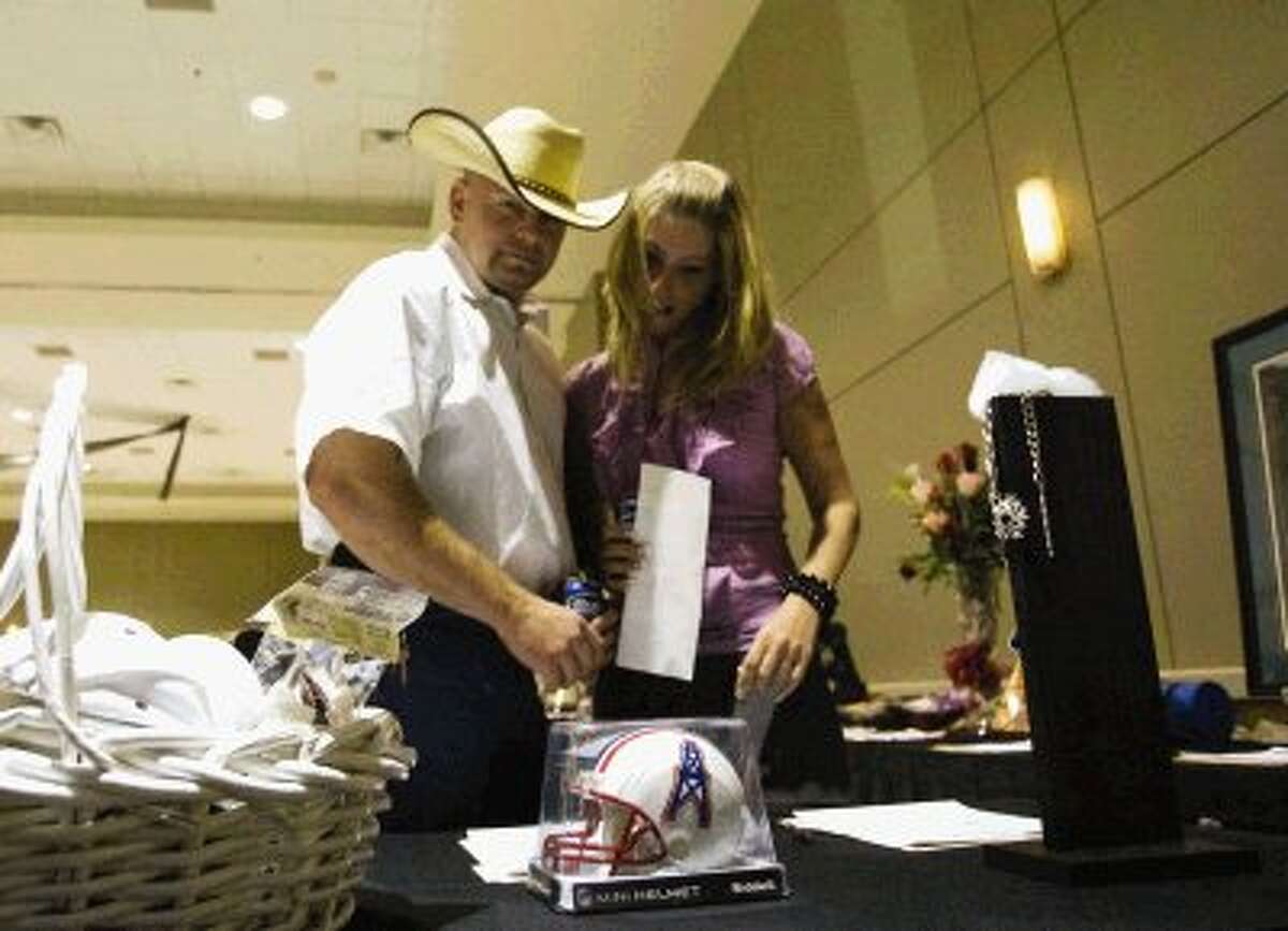 Jack Schultz and Kariy Meneley check out silent auction items during Thursday night’s Conroe Noon Lions Legend of the Lion Dinner, Dance and Auction. More than 500 people attended the event at the Lone Star Convention Center in Conroe.