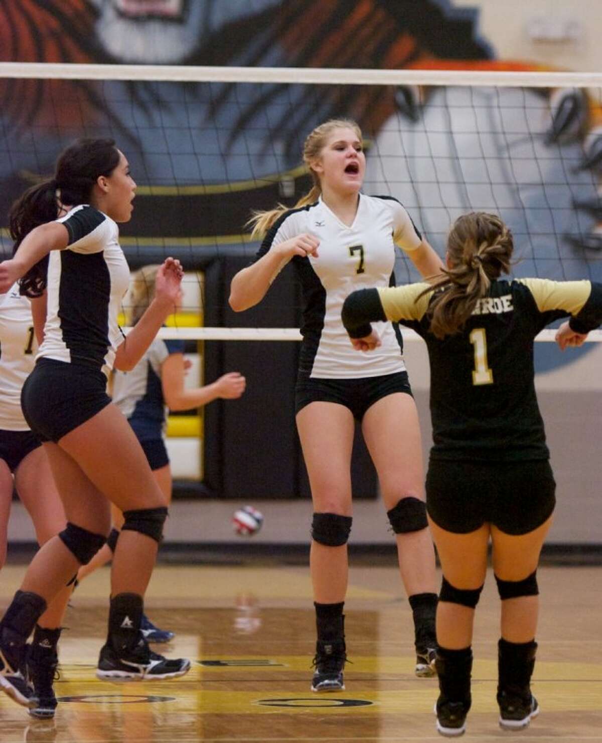 Conroe’s Jane Shute celebrates a point with teammates during Friday night’s game against College Park.