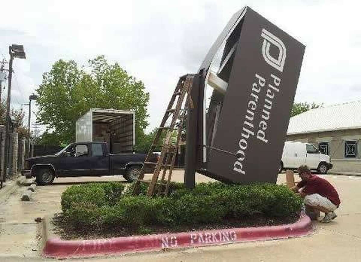 The Planned Parenthood sign in front of the Bryan abortion clinic is torn down after the center closed last month in response to 2011 funding cuts and the abortion restrictions signed into law in July.