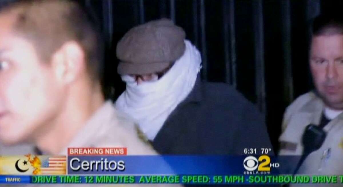 In this image from video provided by CBS2-KCAL9, Nakoula Basseley Nakoula, the man behind the anti-Muslim movie that has inflamed the Middle East, is escorted by Los Angeles County sheriff’s deputies from his home, early Saturday in Cerritos, Calif. Nakoula, 55, was interviewed by federal probation officers at a Los Angeles sheriff’s station but was not arrested or detained, authorities said early Saturday.