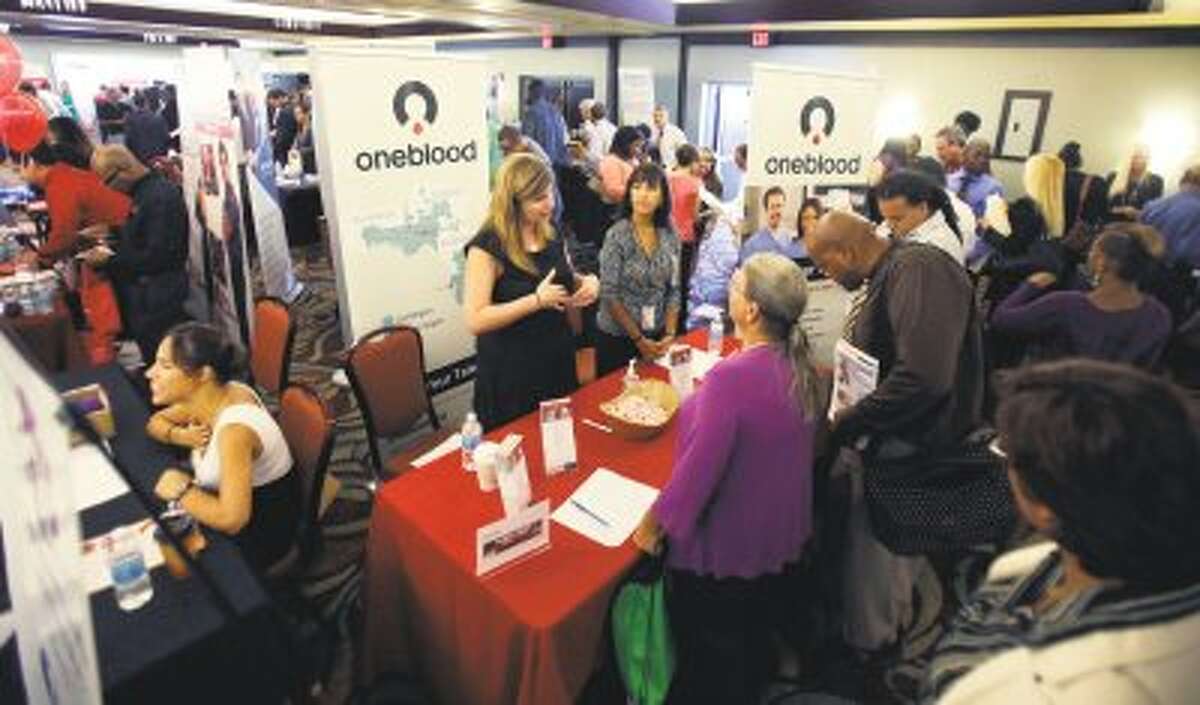 Job seekers check out opportunities during a job fair in Miami Lakes, Fla on Aug. 14. U.S. employers added 169,000 jobs in August, and the unemployment rate dropped to 7.3 percent, the lowest in nearly five years, according to the Labor Department, Friday, Sept. 6.
