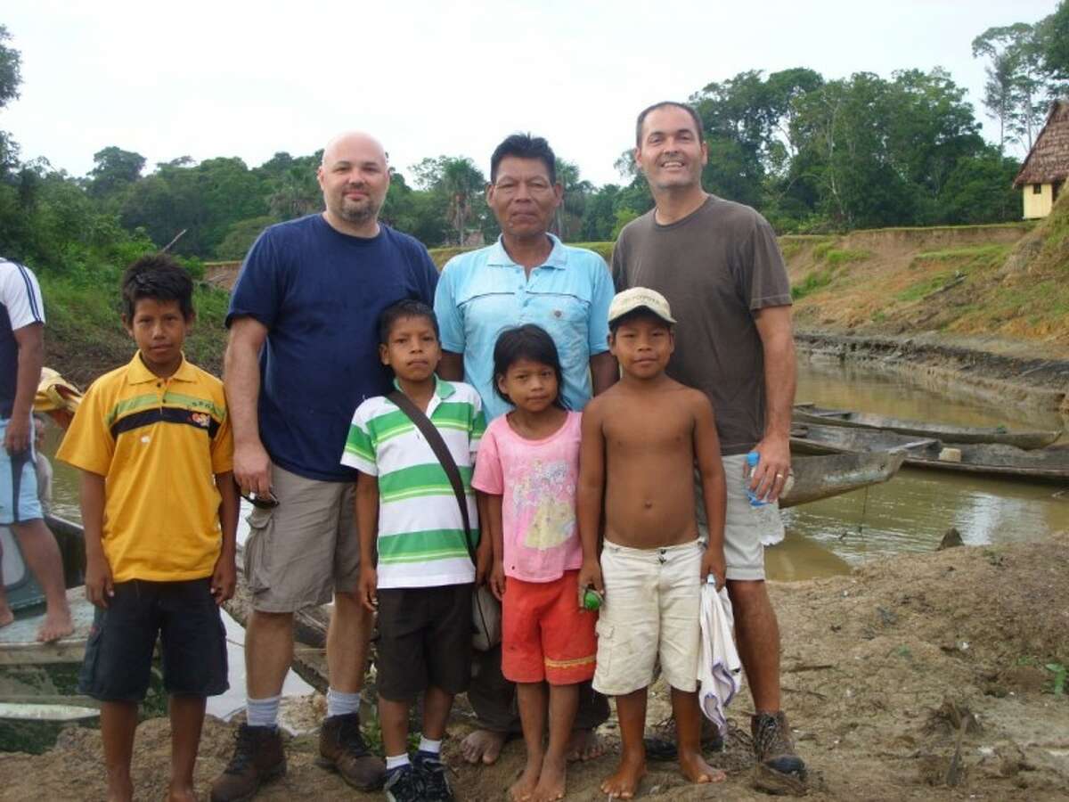 Ralph Clements, left, preaching elder at Sovereign Grace Baptist in Conroe, and Gerald Coleman, left, administrative elder at Sovereign Grace Baptist, stand with Maijuna Tribe Chief Sebastian, center, and tribe members in Peru during a recent mission trip to initiate a relationship with the tribe to teach the Bible.