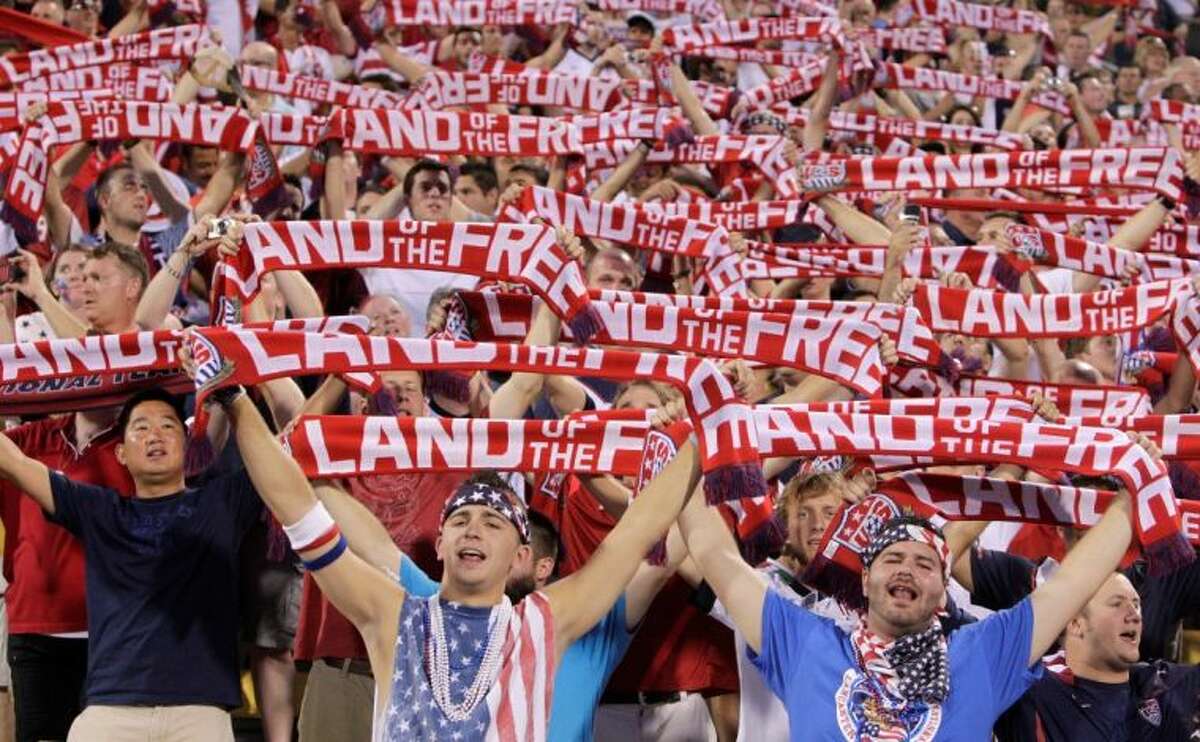 United States fans hold up scarves as they sing the national anthem before the start of a World Cup qualifying match against Mexico on Tuesday in Columbus, Ohio.