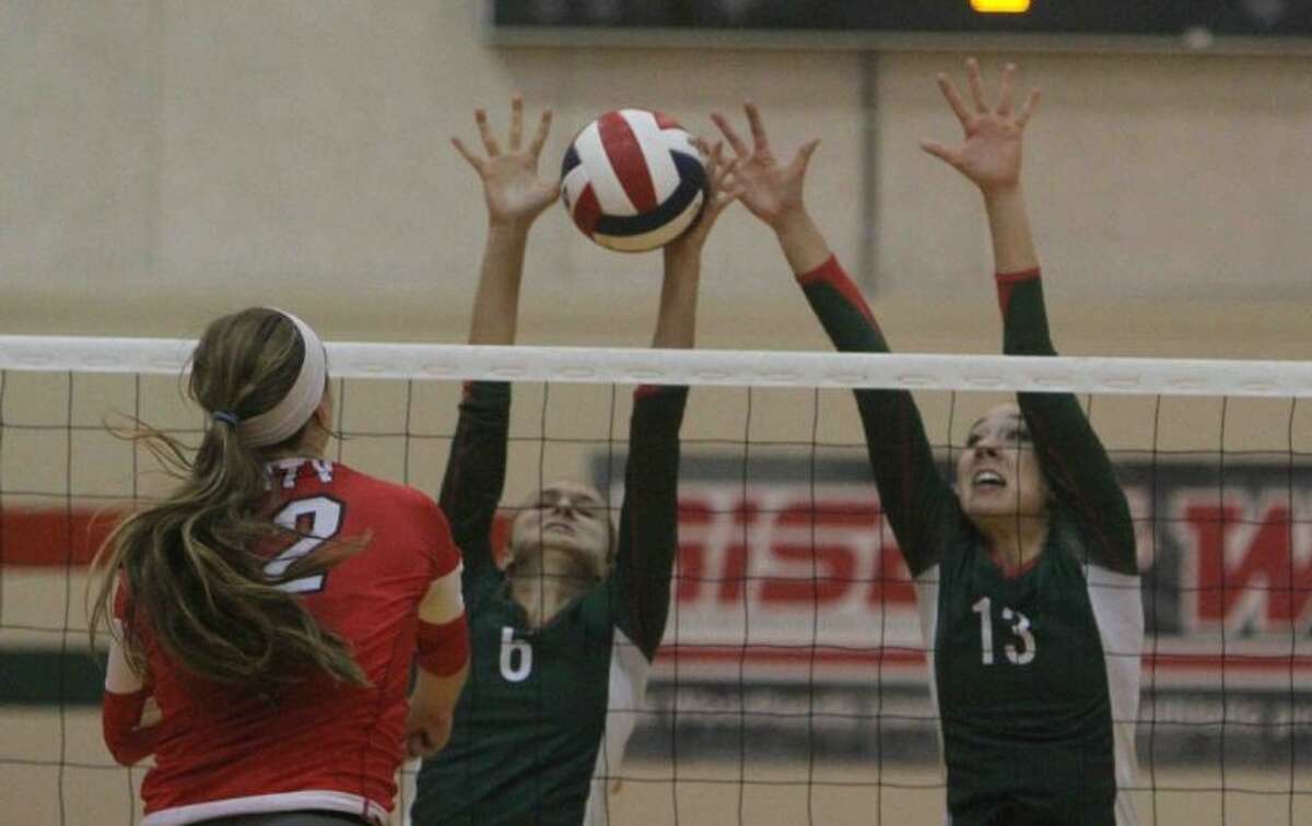 The Woodlands’ Lexi Schnakenburg and Julia Pasch block a shot by Katy’s Zoe Hodges on Tuesday at The Woodlands High School. To view or purchase this photo and others like it, visit HCNpics.com.