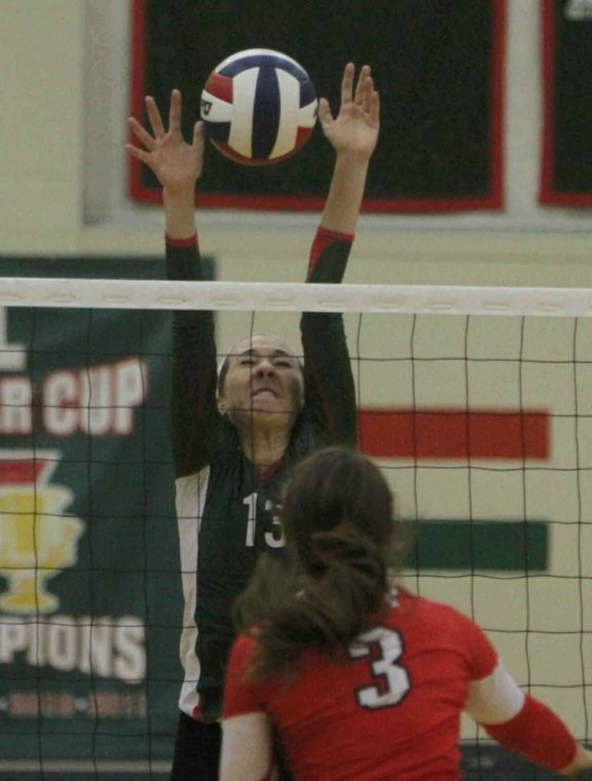 The Woodlands’ Julia Pasch blocks a shot by Katy’s Bailey McFarland on Tuesday at The Woodlands High School. To view or purchase this photo and others like it, visit HCNpics.com.