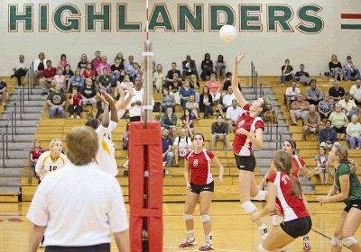 The Woodlands’ Katie Messing (8) jumps to spike during a game last season at The Woodlands High School. The Lady Highlanders as well as many other area teams will open the season tonight.