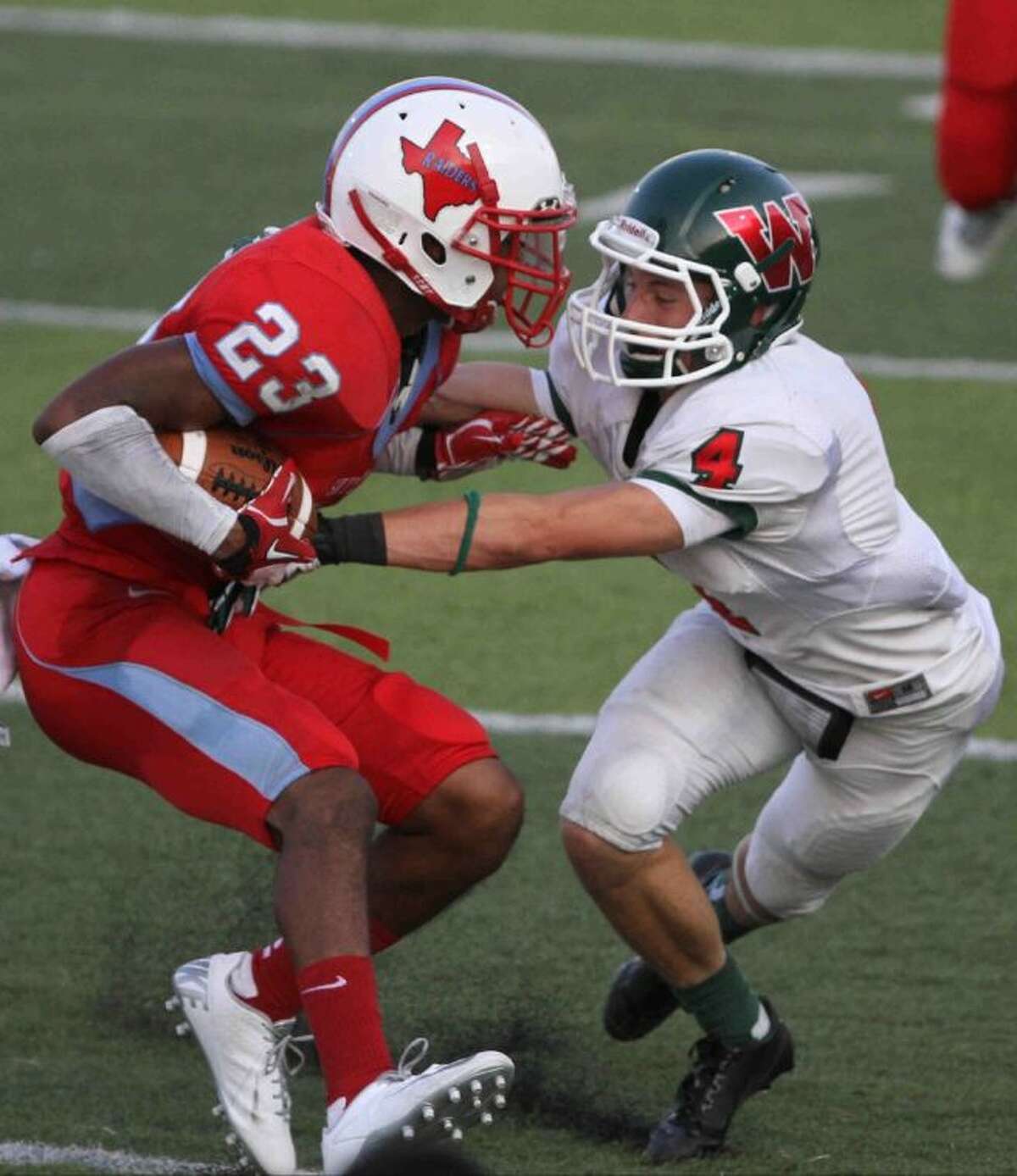 The Woodlands' Tyler Patrick tackles Dallas Skyline's C.J. McGee during a high school football game at Birkelbach Field in Georgetown Saturday. Dallas Skyline defeated The Woodlands 33-30 in overtime. Go to HCNPics.com to view and purchase this photo, and others like it.