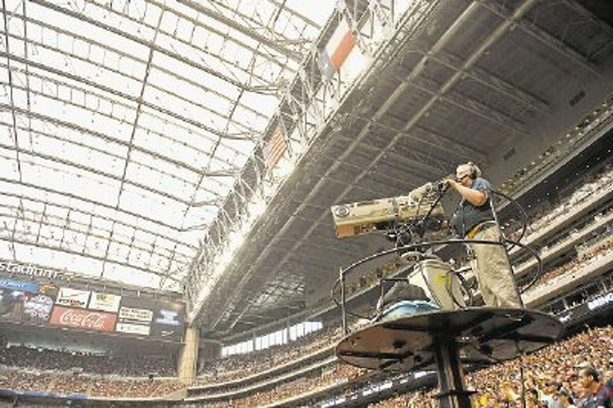 In this Oct. 2, 2011, file photo, a CBS cameraman works during the second quarter of an NFL football game between the Pittsburgh Steelers and Houston Texans at Reliant Stadium. There’s been no reported progress in negotiations between CBS Corp. and Time Warner, which has blocked CBS programming from its customers’ homes in Dallas, Los Angeles and New York since Aug. 2.