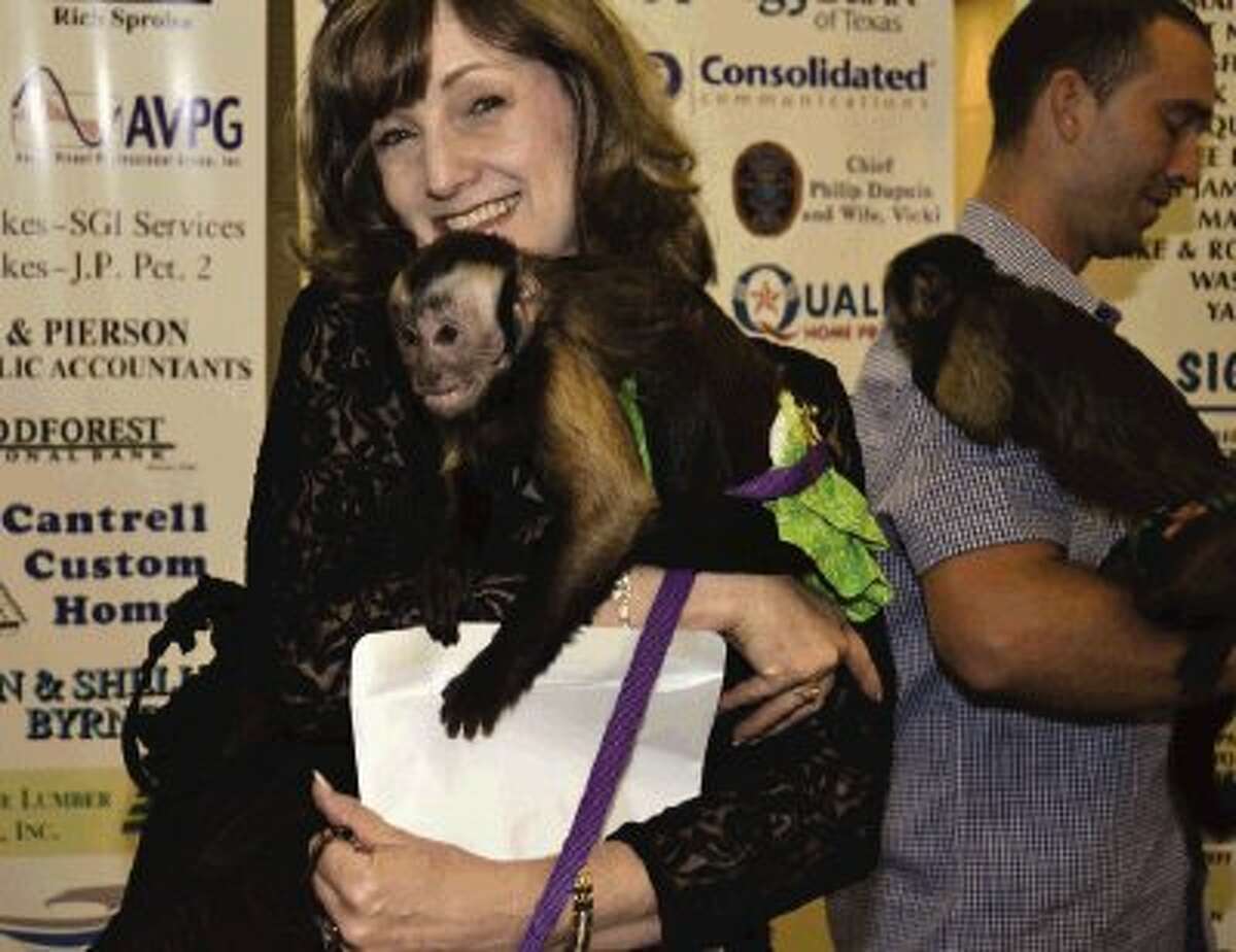 Lion Judy Fetters found a new friend last week at the Conroe Noon Lions Club - Annual ‘Legend of the Lion’ - Dinner/Dance & Auction; using a safari theme, 2-cute Capuchin monkeys welcomed the guests into the event.