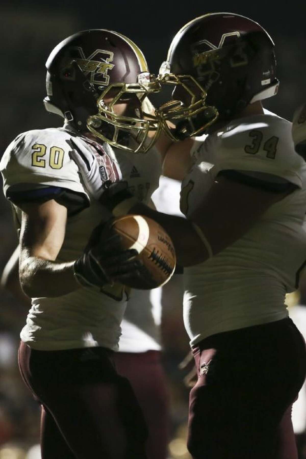 Magnolia West's Chris Nicholson, left, celebrates his touchdown run with teammate Tyler Ray during the Mustangs’ 34-15 victory over Tomball Memorial.