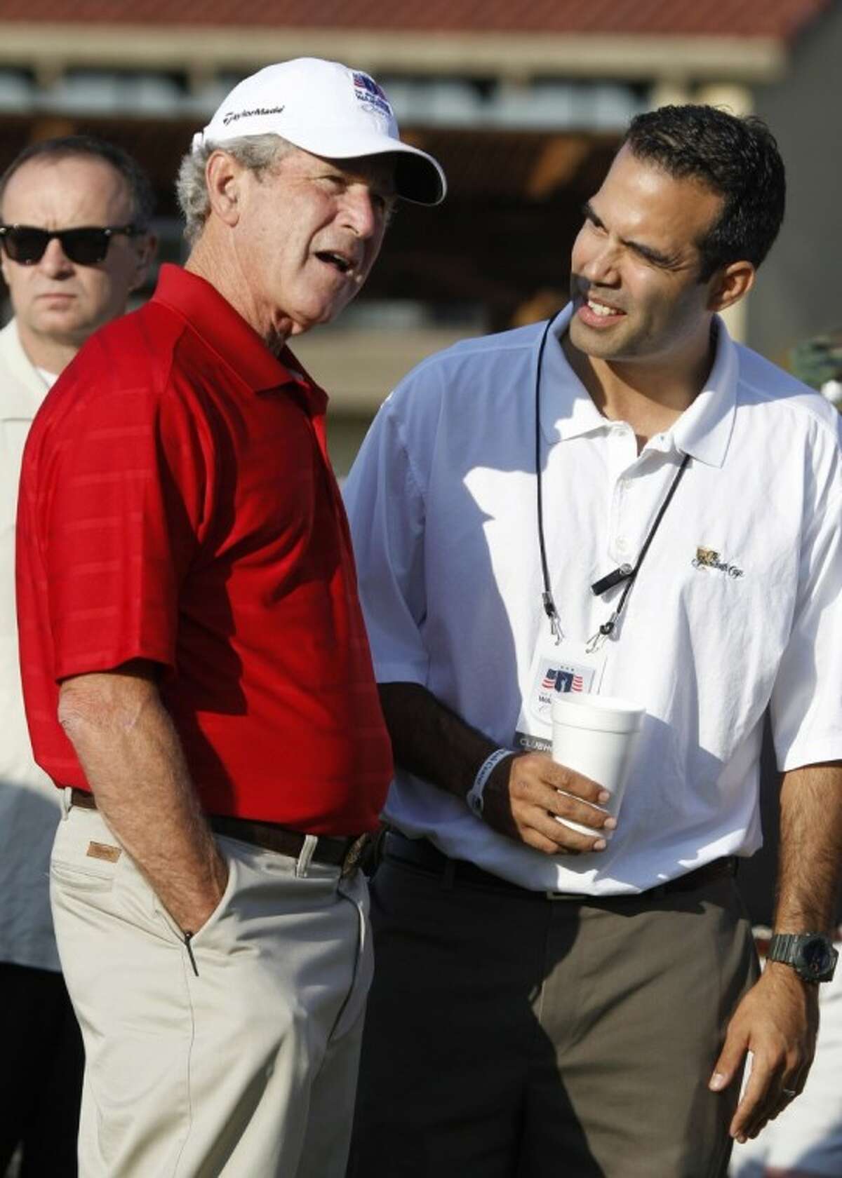 Former President George W. Bush, left, talks with talks with his nephew George P. Bush during the Bush Center Warrior Open in Irving, Texas, Monday. The Warrior Open is a two-day golf tournament featuring members of the U.S. Armed Forces who were severely wounded during the global war against terrorism.