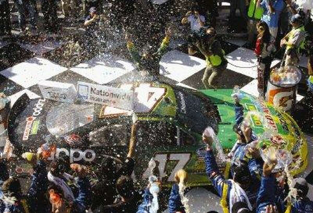 Marcos Ambrose celebrates winning the NASCAR Nationwide Series’ Zippo 200 at The Glen in Watkins Glen, N.Y., Saturday.