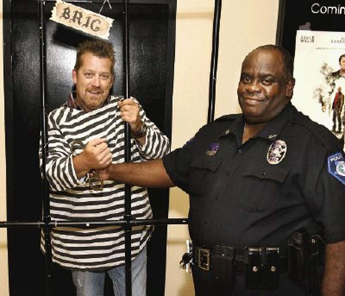The top fundraiser in the annual MDA Lock-Up fundraising event was Scott Cunningham of GTT Inc. in Conroe. He was locked up by Roosevelt Lasker, community liason with the Conroe Police Department.