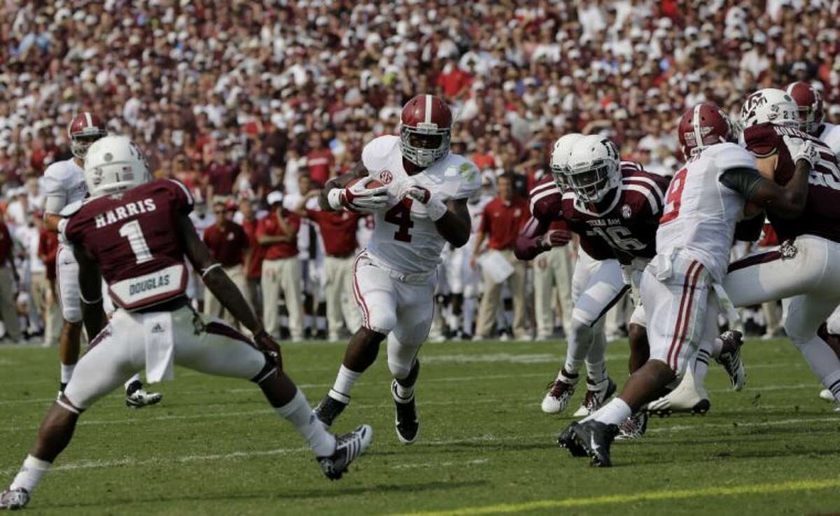 Alabama running back T.J. Yeldon looks for yardage against the Texas A&M defense.