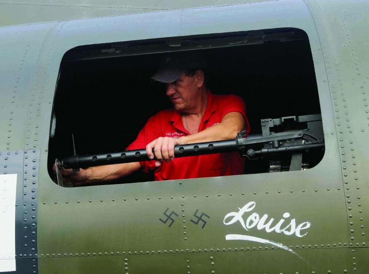 Texas Raiders load master Dave McConkey inspect one of 12 .30-caliber machine guns on a B-17G Flying Fortress at Lone Star Executive Airport Saturday.