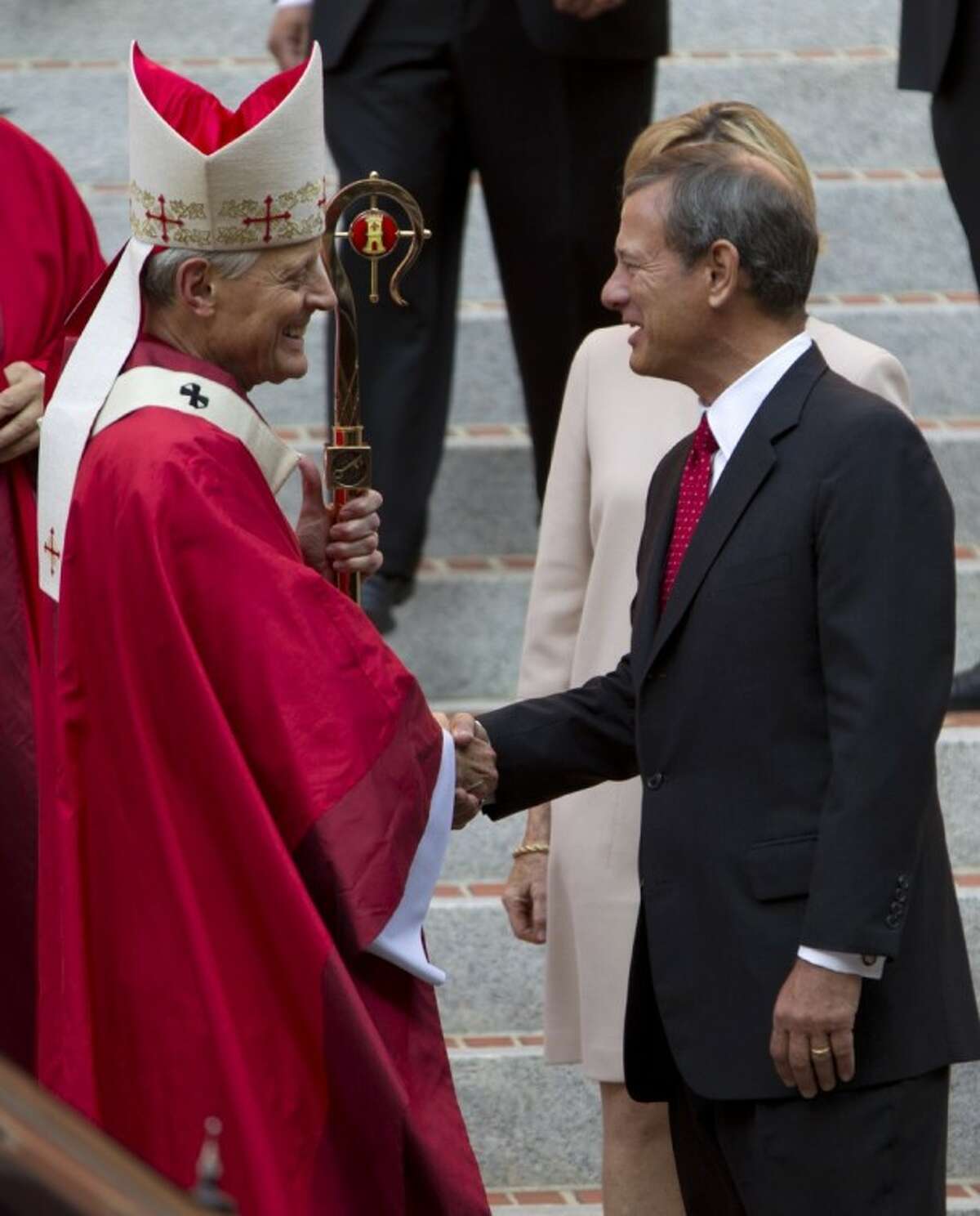 Cardinal Archbishop of Washington Donald Wuerl shake hands with U.S. Supreme Court Chief Justice John G. Roberts after the 60th annual Red Mass at the Cathedral of St. Matthew the Apostle in Washington Sunday. The Red Mass is traditionally held in Washington the day before the Supreme Court's new term opens.