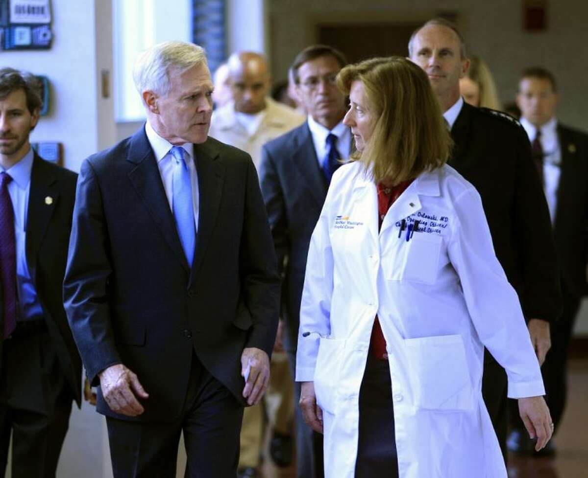 Secretary of the Navy Ray Mabus speaks with Dr. Janis M. Orlowski as they walk in the corridor at Washington Hospital Center, in Washington, on Monday.