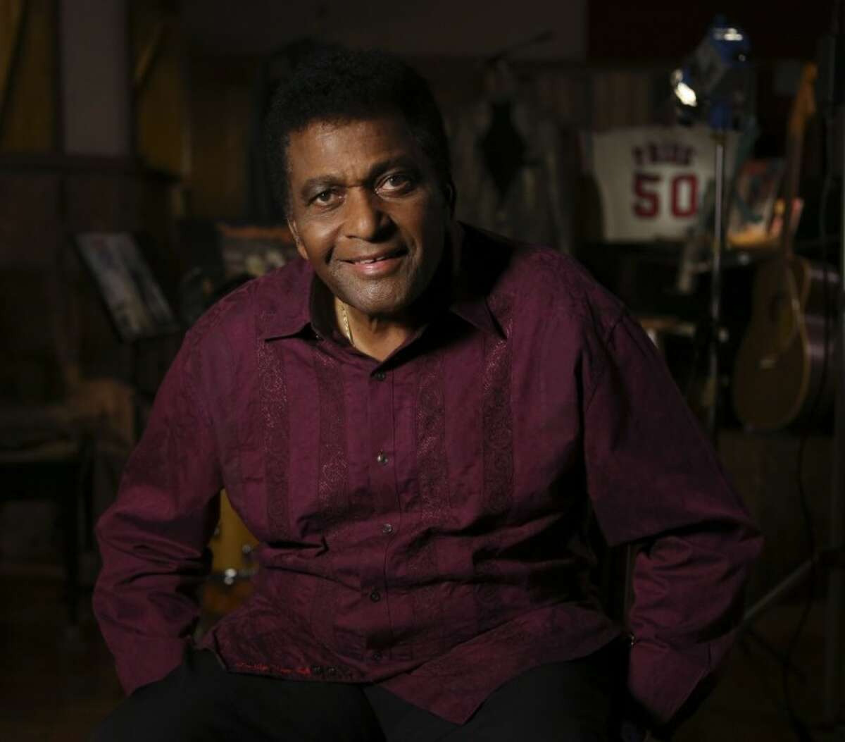 Country music legend Charley Pride smiles for a portrait at his recording studio in Dallas Monday. The Smithsonian has selected Pride to be part of the new National Museum of African American History and Culture opening in 2015 with Pride giving the museum items from his life.