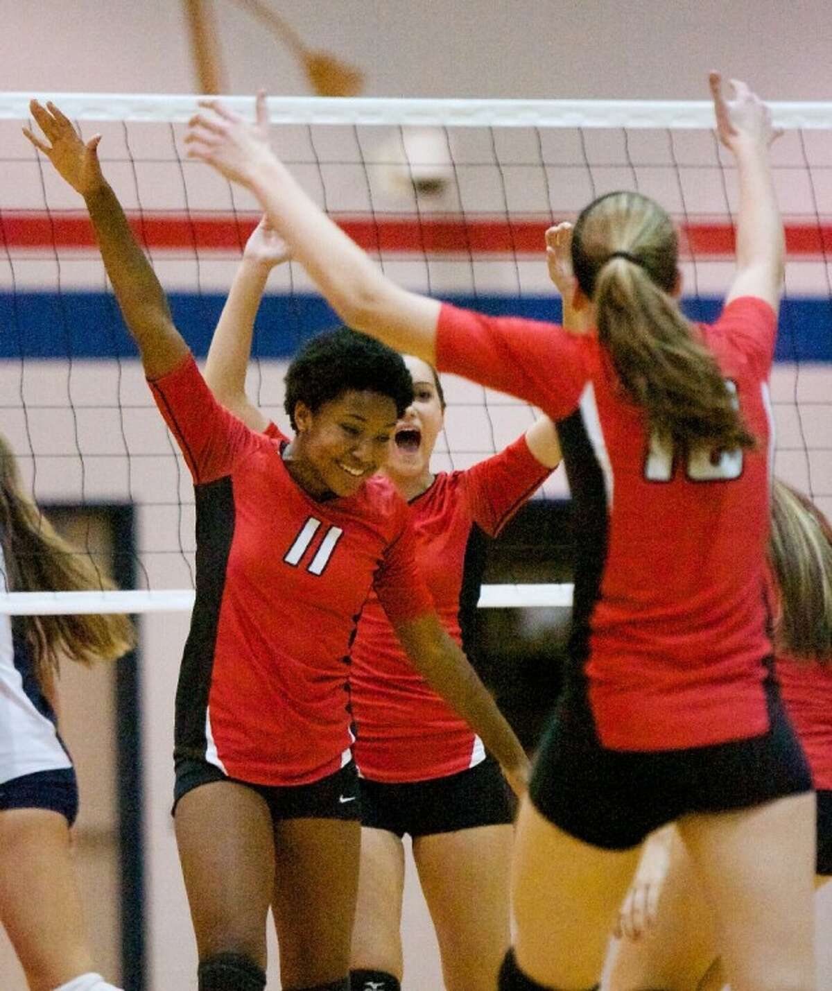 Oak Ridge’s Amber Johnson celebrates a point with teammates during Friday night’s district match against College Park. To purchase or view this photo and others like it, visit: www.yourconroenews.com/photos