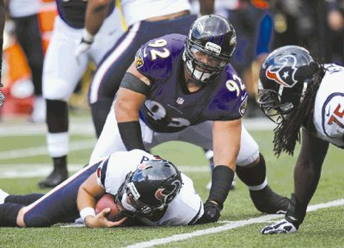 Baltimore Ravens defensive tackle Haloti Ngata (92) lifts himself off of Houston Texans quarterback Matt Schaub after sacking him in the first half of an NFL football game Sunday in Baltimore.