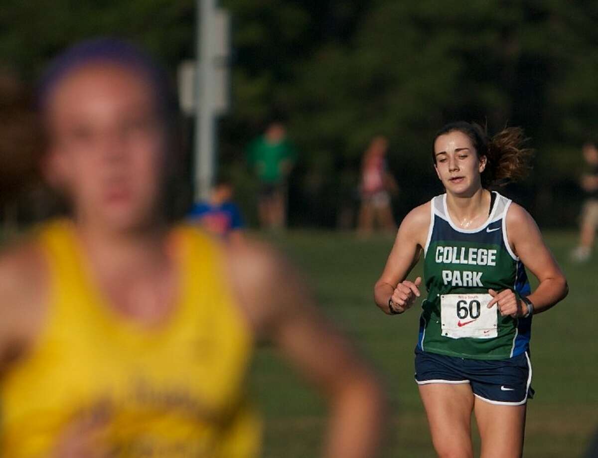 College Park’s Katie Jensen pushes toward the finish line in the 5,000-meter elite girls race during Saturday’s Nike Cross Country Invitational at the Bear Branch Sports Fields in The Woodlands. See girls race story, page 3B.