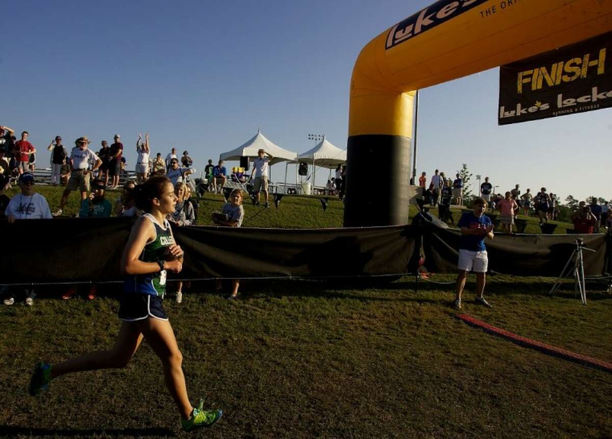 College Park’s Katie Jensen crosses the finish line for second place in the 5,000-meter elite girls race during Saturday’s Nike Cross Country Invitational at the Bear Branch Sports Fields in The Woodlands.