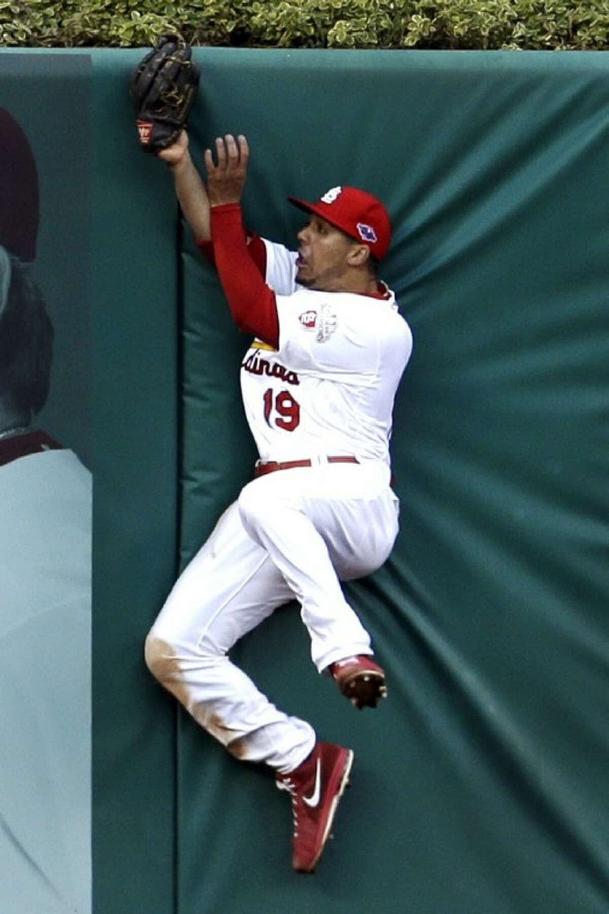 Cardinals center fielder Jon Jay hits the outfield wall after catching a ball hit by Washington’s Danny Espinosa in the NL playoffs. The Cards whipped the Nats 12-4.