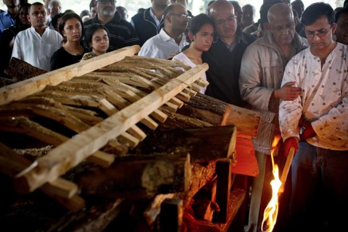 Ramesh Vaya, right, lights the funeral pyre of his wife Malti, who was shot dead in the attack on the Westgate Mall, at her funeral at the Hindu Crematorium in Nairobi, Kenya Tuesday. Ramesh and his brother both lost their wives in the attack. Kenyan President Uhuru Kenyatta says security forces have finally defeated a small group of terrorists after four days of fighting at the Nairobi mall.