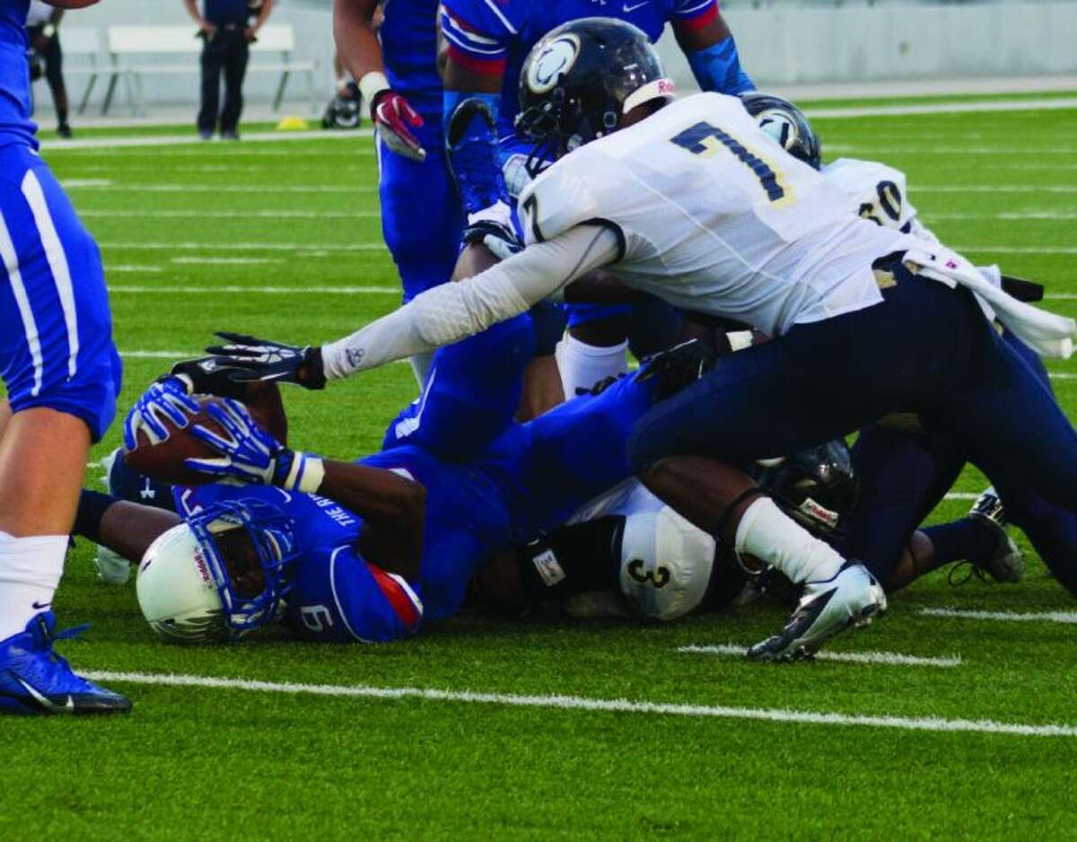Oak Ridge’s Kwame Etwi stretches the ball toward the goal line against Nimitz on Saturday night at Woodforest Bank Stadium in Shenandoah. To view or purchase this photo and others like it, visit HCNpics.com.