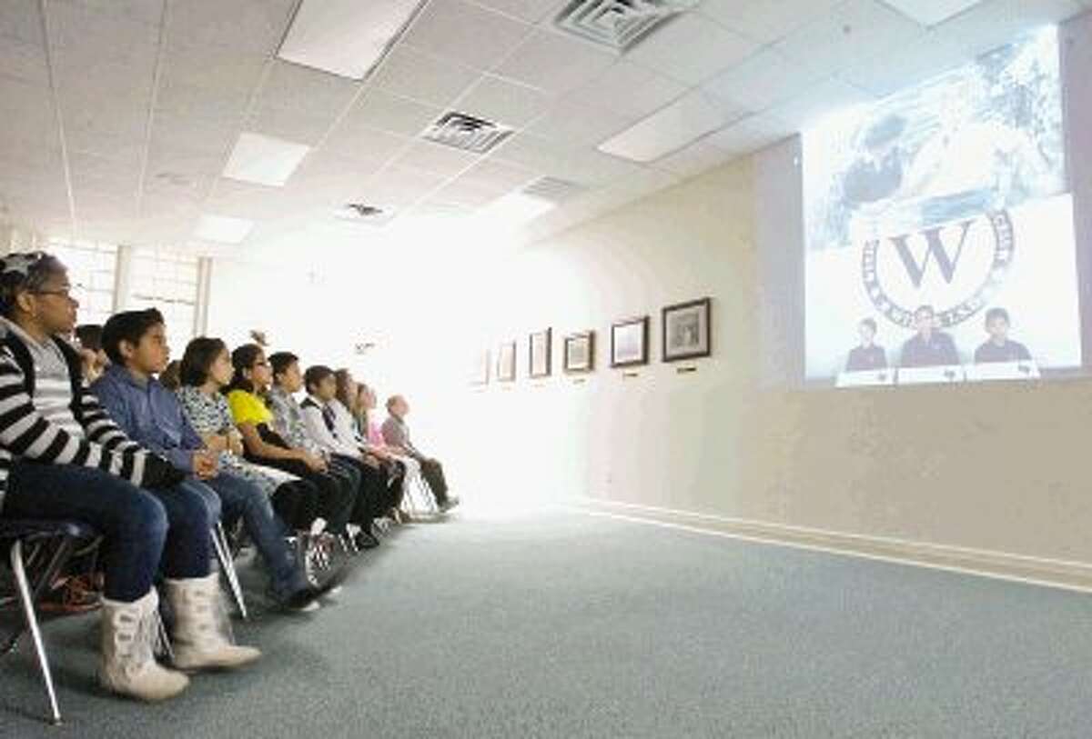 Willis Independent School District students watch as classmates, Crash Nesom, Keely Wilson and Edin Inestroza interact with NASA astronauts Sunita Williams and Kevin Ford during a video conference Thursday as part of the International Education Week and the Student Spaceflight Experiment Program. The video conference included over 9,500 students from across 24 communities in the U.S. and Canada.