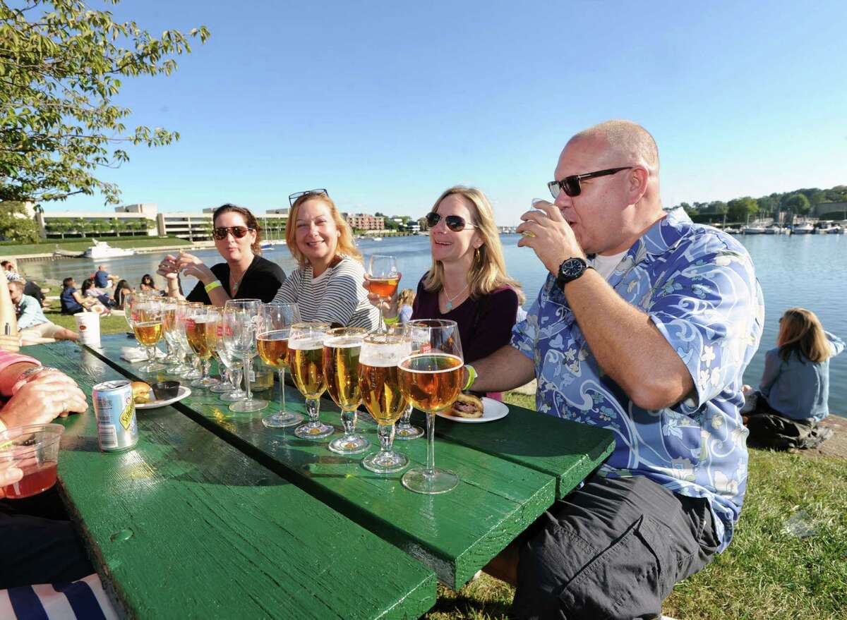 At right, Frank Furdyna of Fairifled and a group of friends enjoyed cold Stella Artois beer during the Greenwich Wine & Food Festival at Roger Sherman Baldwin Park in Greenwich, Conn., Saturday, Sept. 24, 2016. The annual event benefited Paul Newman's Hole in the Wall Gang Camp, Wholesome Wave and the Greenwich Department of Parks and Recreation, featured a Culinary Village with food and beverage tastings from 90-plus vendors, live music headlined by Ziggy Marley and celebrity chef cooking demonstrations and tastings.