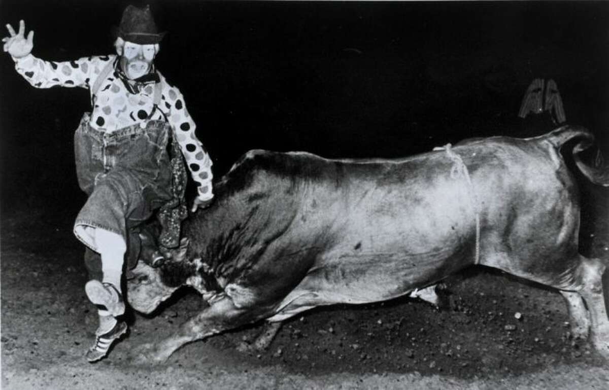 In this photo provided by Marvin "Quail" Dobbs, Marvin "Quail" Dobbs is lifted by a bull during a 1970 rodeo in Hill City, Kansas. Dobbs is a retired rodeo clown and former Justice of the Peace in Coahoma, Texas.