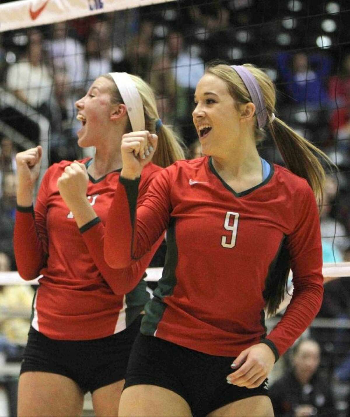 The Woodlands' Courtney Eckenrode (9) and Rachel Reed (12) celebrate a point during a Class 5A UIL Volleyball State Championship game Saturday, Nov. 23, 2013, in Garland, Texas. The Woodlands defeated San Antonio Churchill in straight sets to became the 18th undefeated volleyball state champion in UIL history since 1967. To purchase this photo and other like it, visit HCNPics.com.