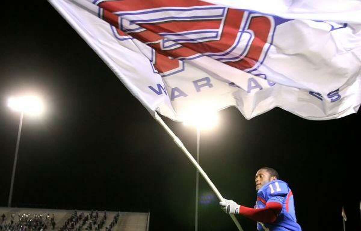 Oak Ridge’s Armontre Sneed waves the War Eagle flag as he celebrates Thursday night’s 21-20 victory over Kingwood at Woodforest Bank Stadium in Shenandoah. To purchase this photo or others like it, visit http://hcnonline.mycapture.com.