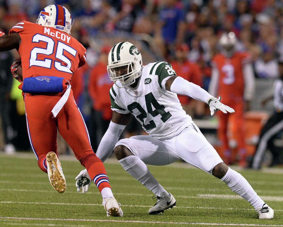 In this Thursday, Sept. 15, 2016, photo, New York Jets cornerback Darrelle Revis (24) prepares to tackle Buffalo Bills running back LeSean McCoy (25) during the first half of an NFL football game in Orchard Park, N.Y. Revis says a report that he came to training camp "out of shape" and is contributing to his struggles is a result of his former agents taking "a shot" at him. (AP Photo/Adrian Kraus) ORG XMIT: NY187