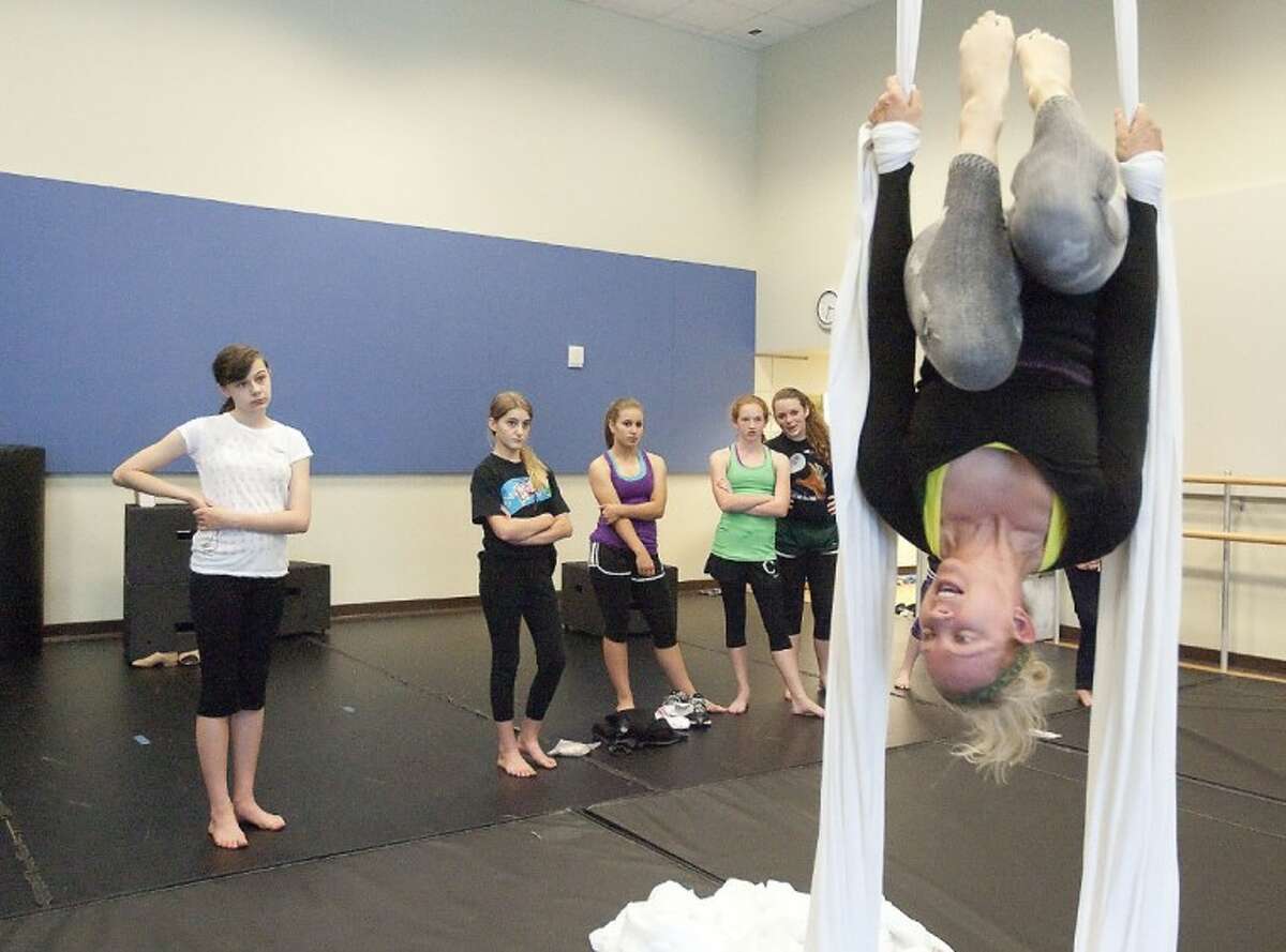 Jill Crook demonstrates silk aerial techniques to dance students Friday at the John Cooper School.