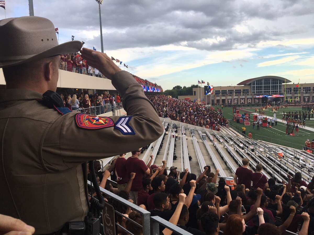 A group of Texas State students raise their fists while sitting during the national anthem before a college football game between No. 6 University of Houston and Texas State at Bobcat Stadium in San Marcos on Saturday, Sept. 24, 2016. 