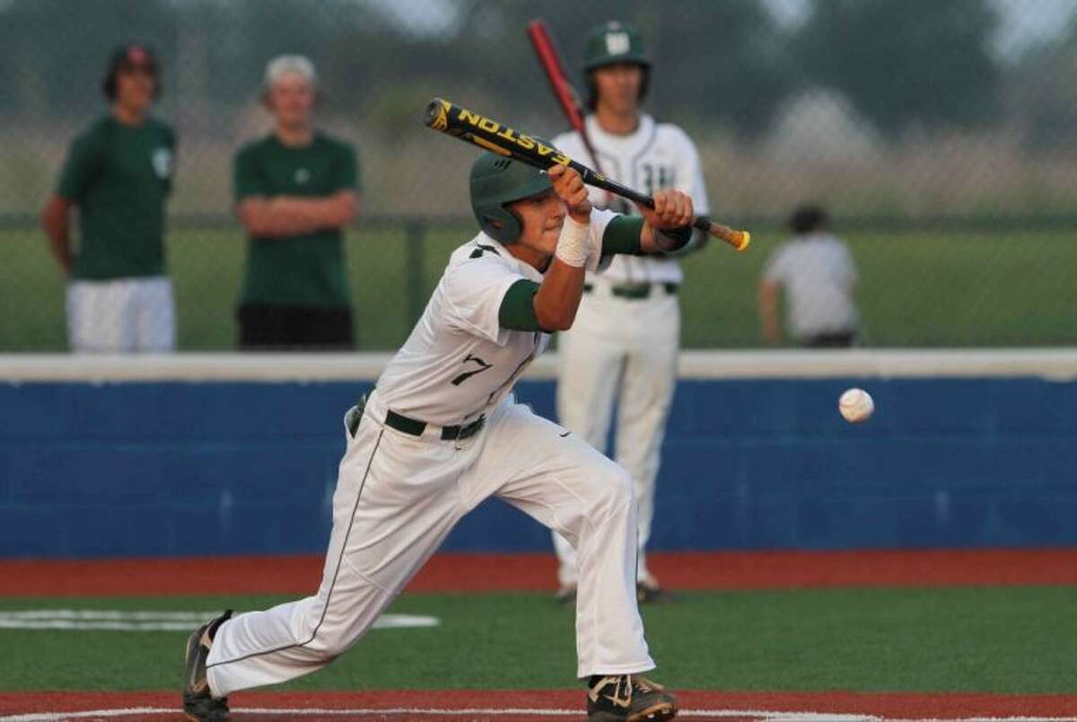 The Woodlands’ Luke Sherley lays down a bunt during Game 1 against Round Rock in the Region II-5A quarterfinals Thursday night at Mumford High School. To view or purchase this photo and others like it, visit HCNpics.com.