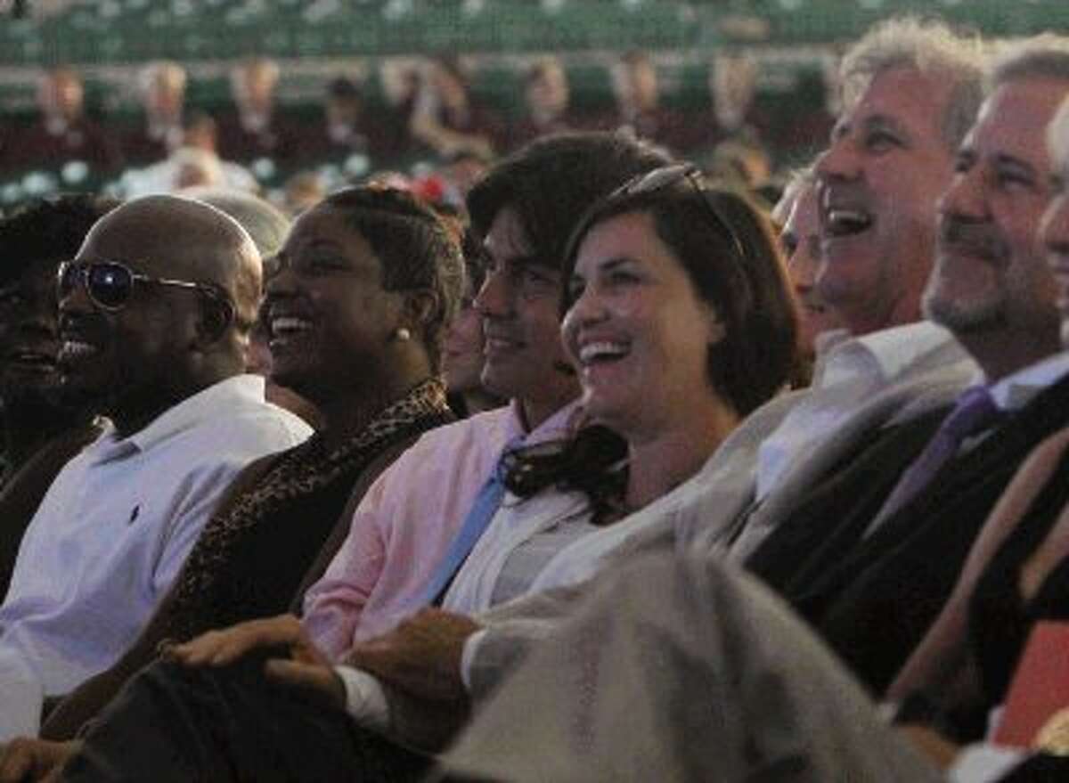 Members of the Mitchell family and their friends laugh as Todd Mitchell recalls memories of his father, George Mitchell, during a celebration of his life at the Cynthia Woods Mitchell Pavilion Thursday. To view more photos of the event, go to HCNPics.com.