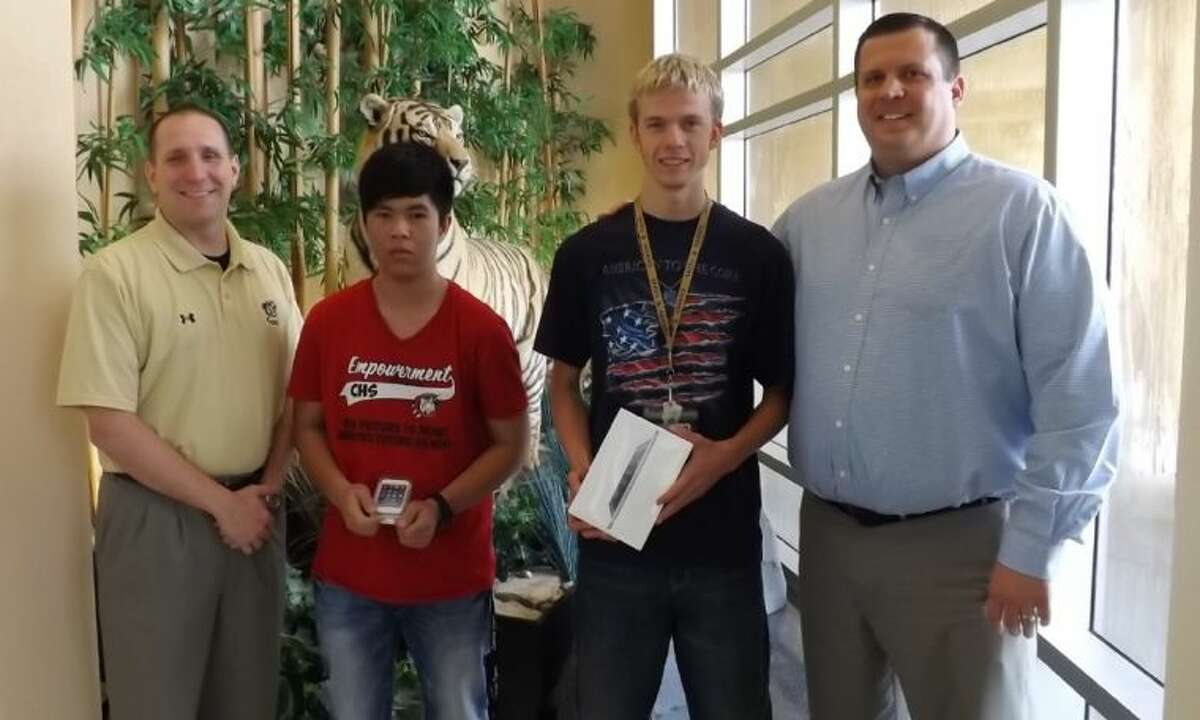 The Conroe Noon Lions Club sponsored a “perfect attendance” contest at Conroe High School during the last nine weeks of school and gave away an iPod touch and iPad mini as grand prizes. Pictured (left to right): Dr. Curtis Null, CHS principal, Vien Pham, Jacob McCauley and Warner Phelps, CNLC Leo Club liaison.