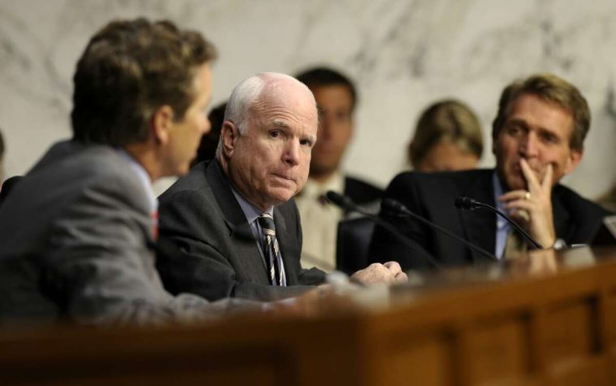 Senate Foreign Relations Committee members Sen. John McCain, R-Ariz, center, and Sen. Rand Paul, R-Ky., left, talk on Capitol Hill in Washington Wednesday during the committee’s hearing to consider the authorization for use of military force in Syria. Sen. Jeff Flake, R-Ariz. is at right.
