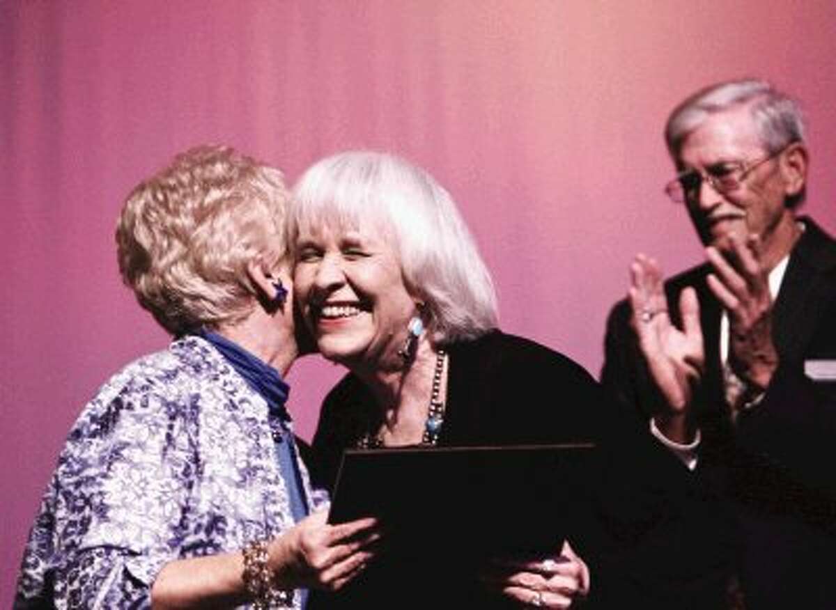 Peggy Miller, right, smiles as she is presented with a Special Senatorial Certificate from State Senator Robert Nichols by Luine Hancock, left, before the start of the Larry Gatlin concert Saturday at the Crighton Theatre in Conroe. Miller received the certificate in honor and recognition of her leadership, public service and many lifetime achievements. To view or order this photo and others like it, visit HCNPics.com.