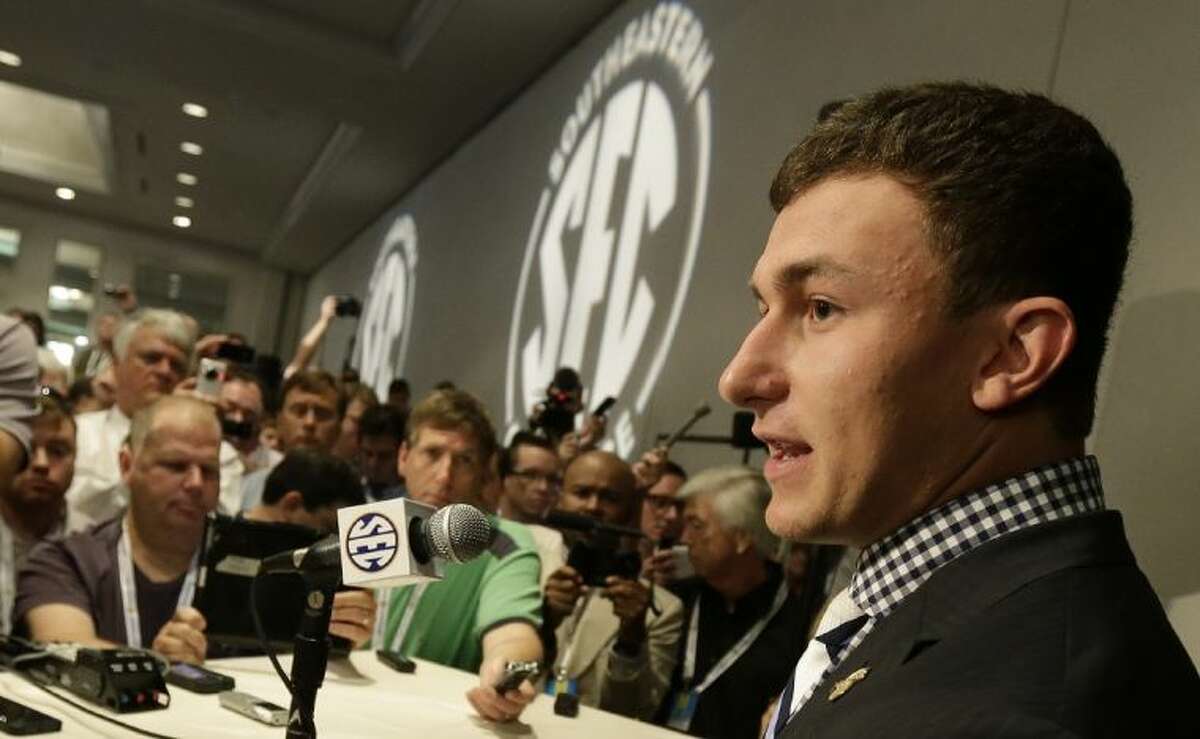 Texas A&M quarterback Johnny Manziel talks with reporters during the Southeastern Conference football media days on Wednesday in Hoover, Ala.
