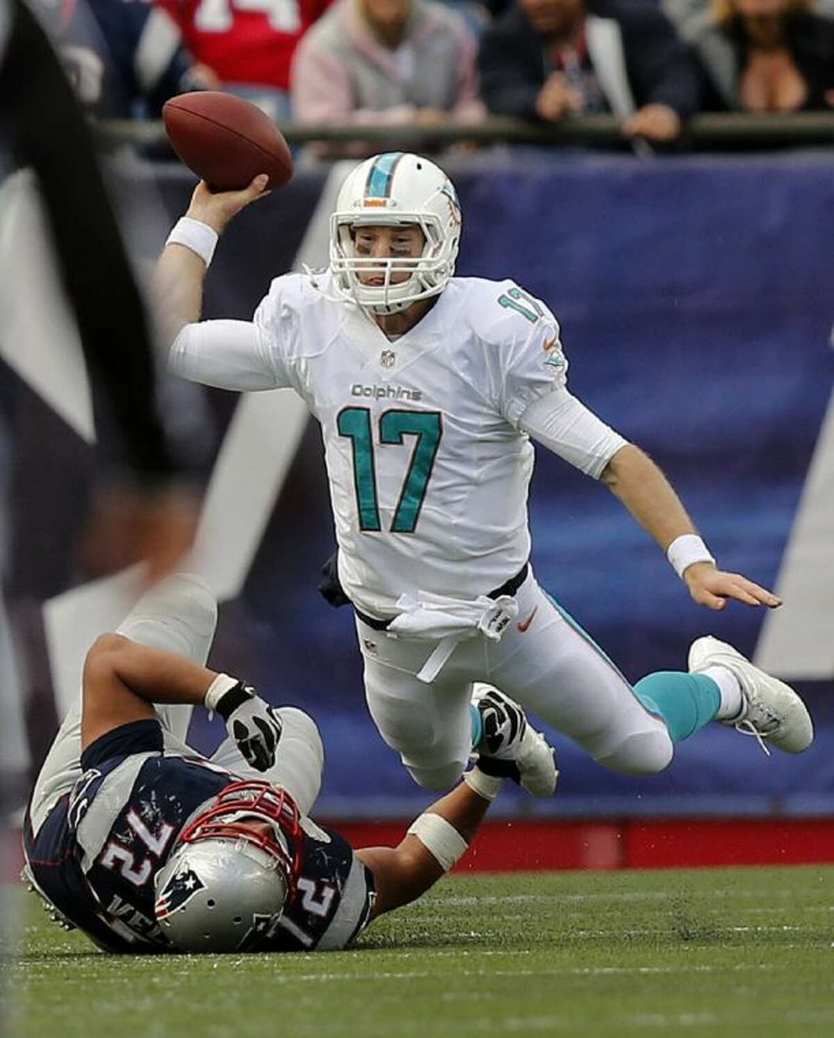 Miami Dolphins quarterback Ryan Tannehill gets rid of the ball as he is tackled by New England Patriots defensive tackle Joe Vellano on Sunday in Foxborough, Mass. The Patriots won 27-17.
