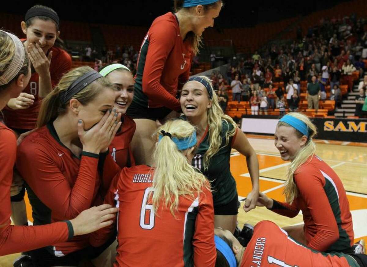 The Woodlands players celebrate after defeating Plano in straight sets to win the Region II-5A championship on Saturday at Bernard G. Johnson Coliseum on the campus of Sam Houston State University in Huntsville. To view or purchase this photo and others like it, visit HCNpics.com.